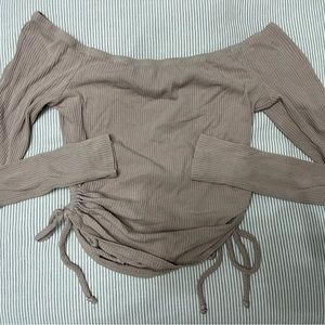 Trendy long sleeve top. Circles for design on sides.